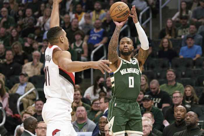 Milwaukee Bucks guard Damian Lillard (0) shoots against Portland Trail Blazers guard Malcolm Brogdon (11)